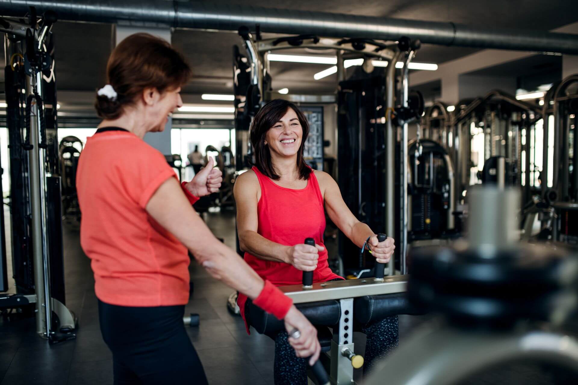 two-cheerful-senior-women-in-gym-doing-strength-wo-2024-10-18-09-31-41-utc.jpg